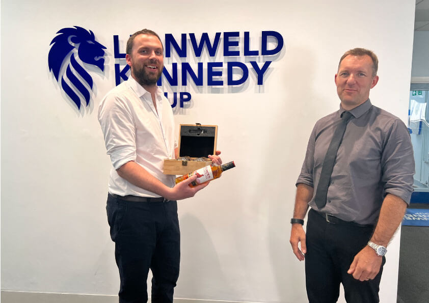 Tom Craw receiving a sustainable gift from Lionweld Kennedy 