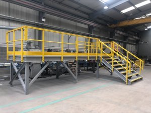 Yellow and grey large GRP access platform with GRP staircase. 